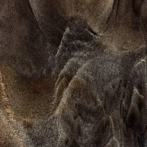 Wrafts of Mist": Abstract close-up photograph depicting swirling patterns in a mixture of volcanic black sand and white beach sand on the shores of Bali, Indonesia. Evokes the transient beauty of mist flowing around mountain ranges.